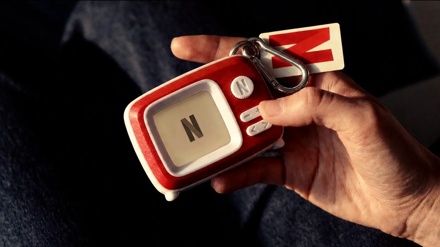 Netflix Charms: red and white retro-TV-shaped keychains, one showing the Netflix N